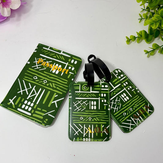 a set of green and white patterned luggage tags and a matching green passport cover, all placed on a white surface.