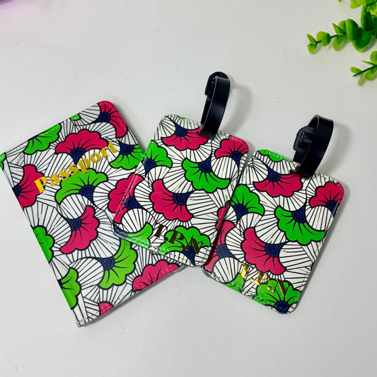 three colorful luggage tags with a floral pattern, placed on a white surface.