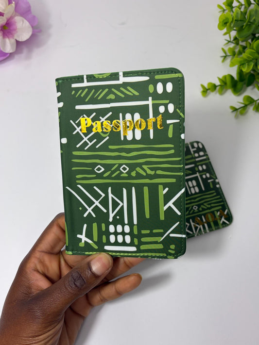 A hand holding a green passport holder with a patterned design.