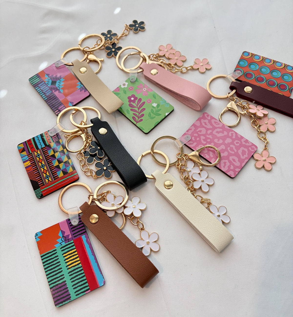 a collection of colorful keychains and charms, each with unique designs and patterns.