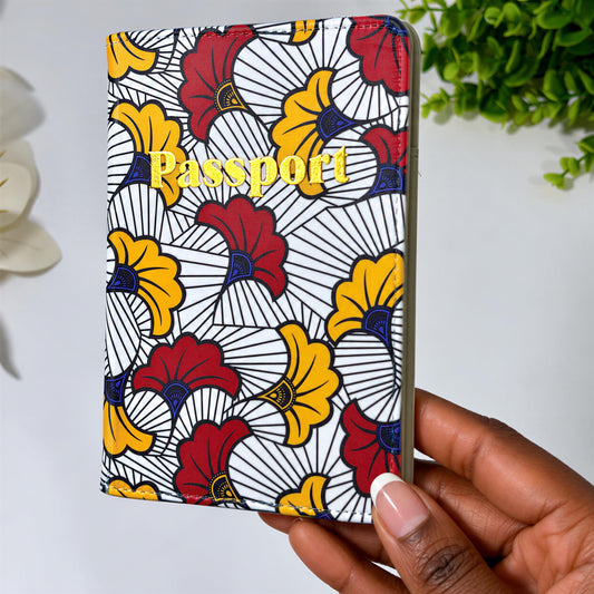 A colorful passport holder with a floral pattern is being held in a hand.