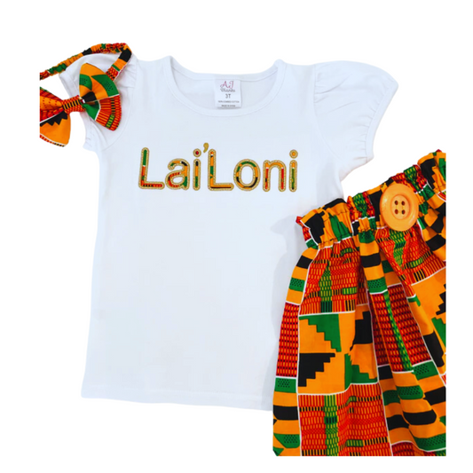Girls' vibrant kente fabric skirt set with a personalized embroidered t-shirt and a matching headband